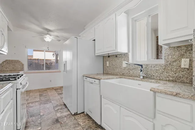 a kitchen with a sink stove and cabinets