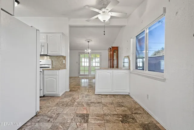 a view of a kitchen with a sink and dishwasher cabinets