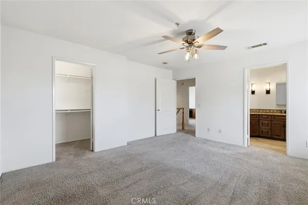 a view of an empty room with a ceiling fan