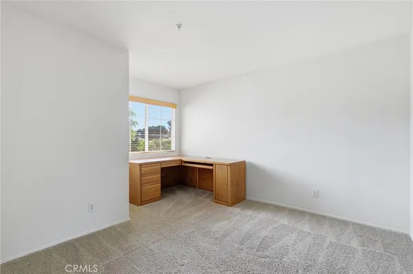 an empty room with furniture and window