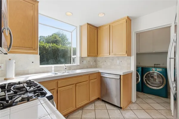 a kitchen with a sink a stove and cabinets