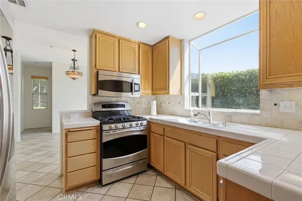 a kitchen with a stove a sink and a microwave
