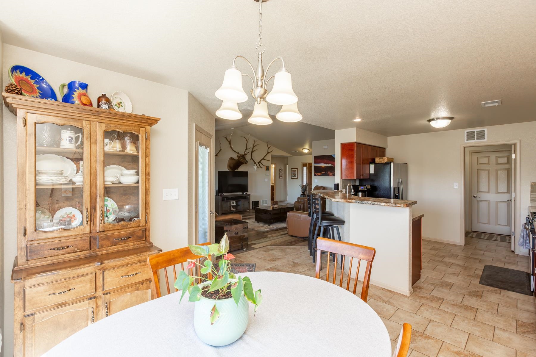 103 Red Rocks Street Fruita, CO 81521 - Photo 32 of 39 a living room with kitchen island furniture and a chandelier
