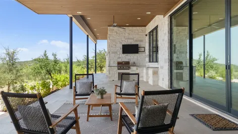 a dining room with furniture and a floor to ceiling window