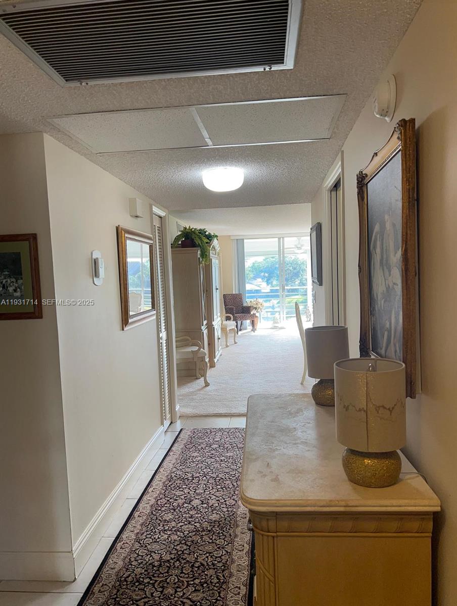 821 Cypress Boulevard, Unit 312 Pompano Beach, FL 33069 - Photo 12 of 52 a living room with furniture and a large window