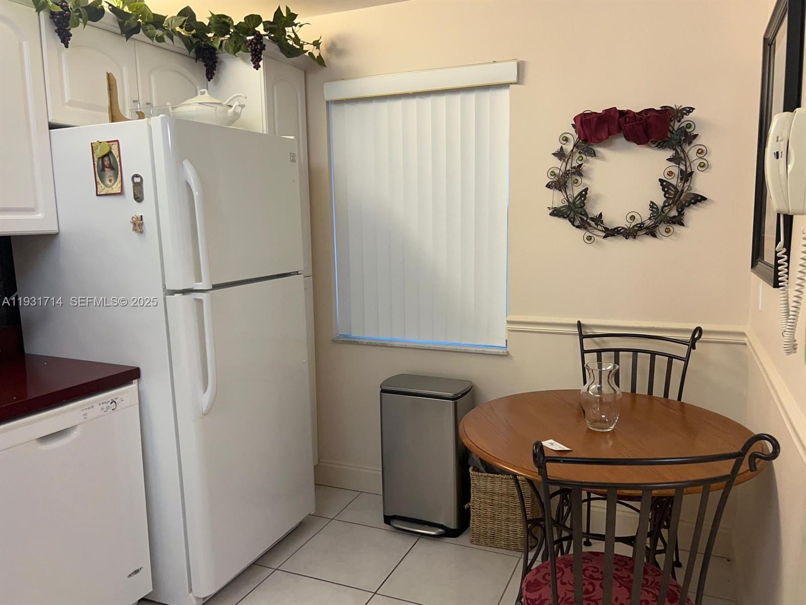821 Cypress Boulevard, Unit 312 Pompano Beach, FL 33069 - Photo 19 of 52 a white refrigerator freezer sitting in a kitchen with a white refrigerator