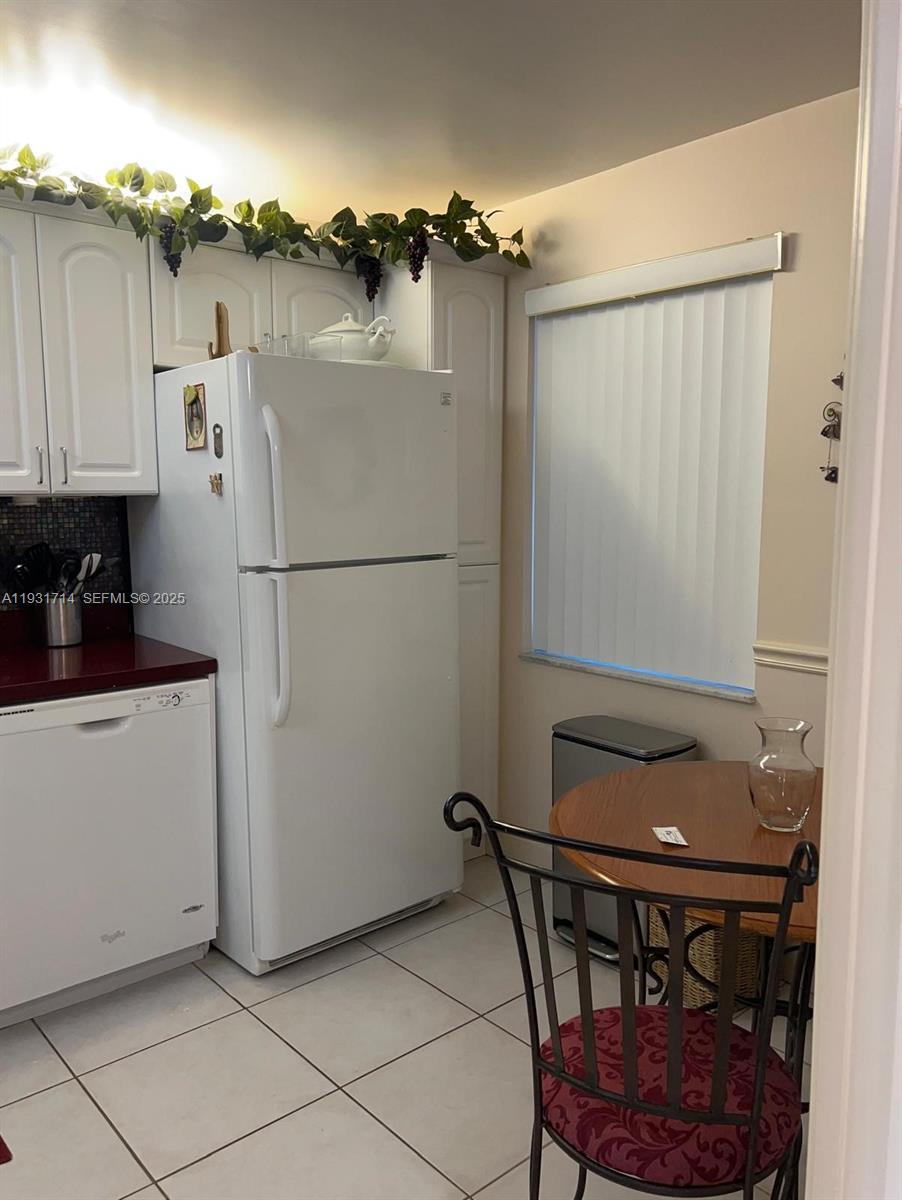 821 Cypress Boulevard, Unit 312 Pompano Beach, FL 33069 - Photo 20 of 52 a white refrigerator freezer sitting in a kitchen
