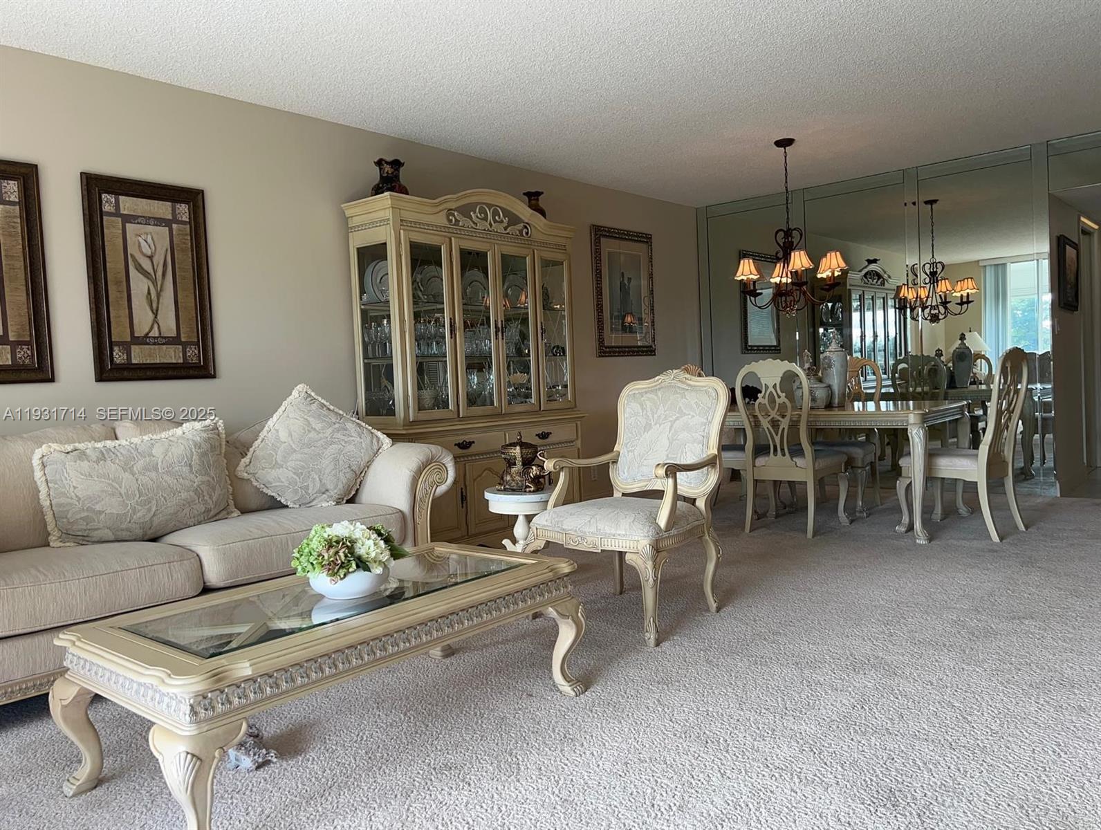 821 Cypress Boulevard, Unit 312 Pompano Beach, FL 33069 - Photo 2 of 52 a living room with furniture a dining table and a chandelier