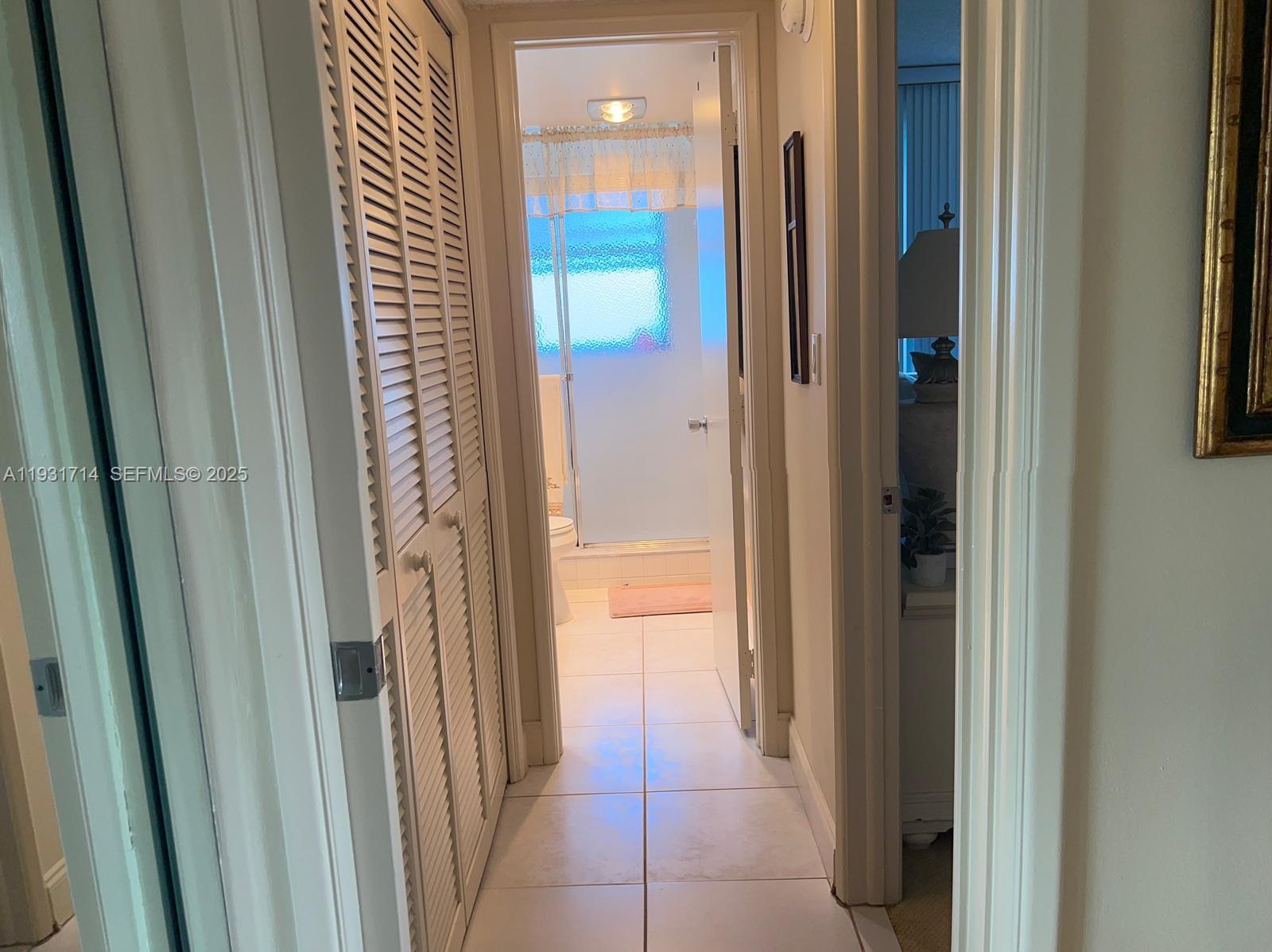 821 Cypress Boulevard, Unit 312 Pompano Beach, FL 33069 - Photo 21 of 52 a view of a bathroom from a corridor
