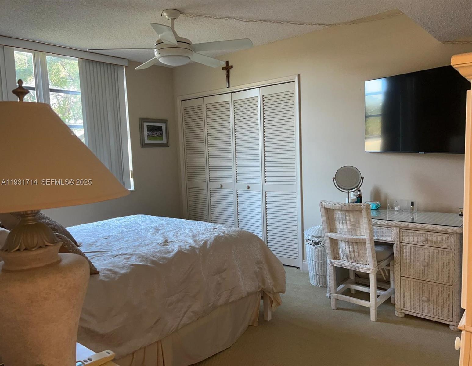 821 Cypress Boulevard, Unit 312 Pompano Beach, FL 33069 - Photo 23 of 52 a bedroom with a bed and a flat screen tv
