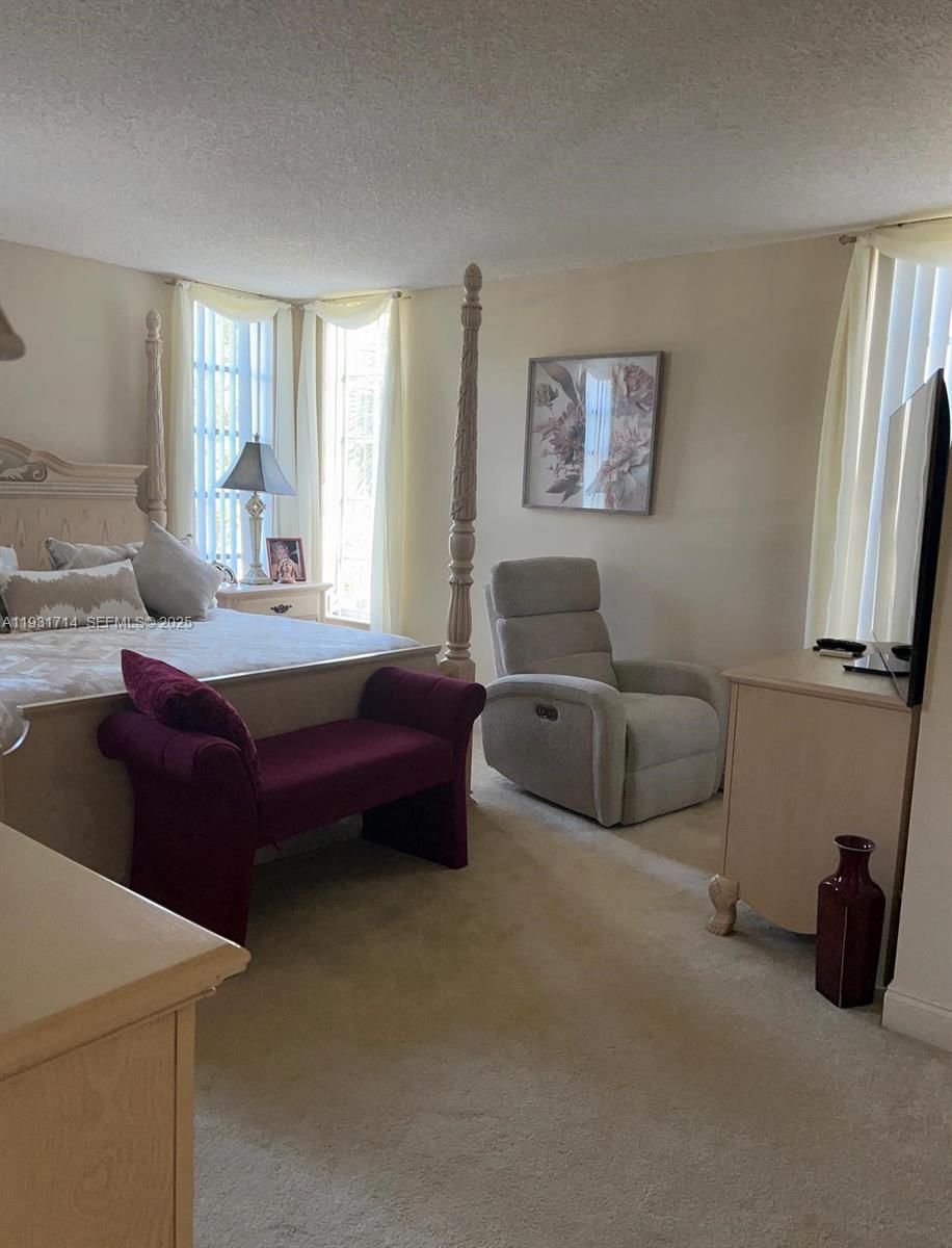 821 Cypress Boulevard, Unit 312 Pompano Beach, FL 33069 - Photo 27 of 52 a living room with furniture and a window