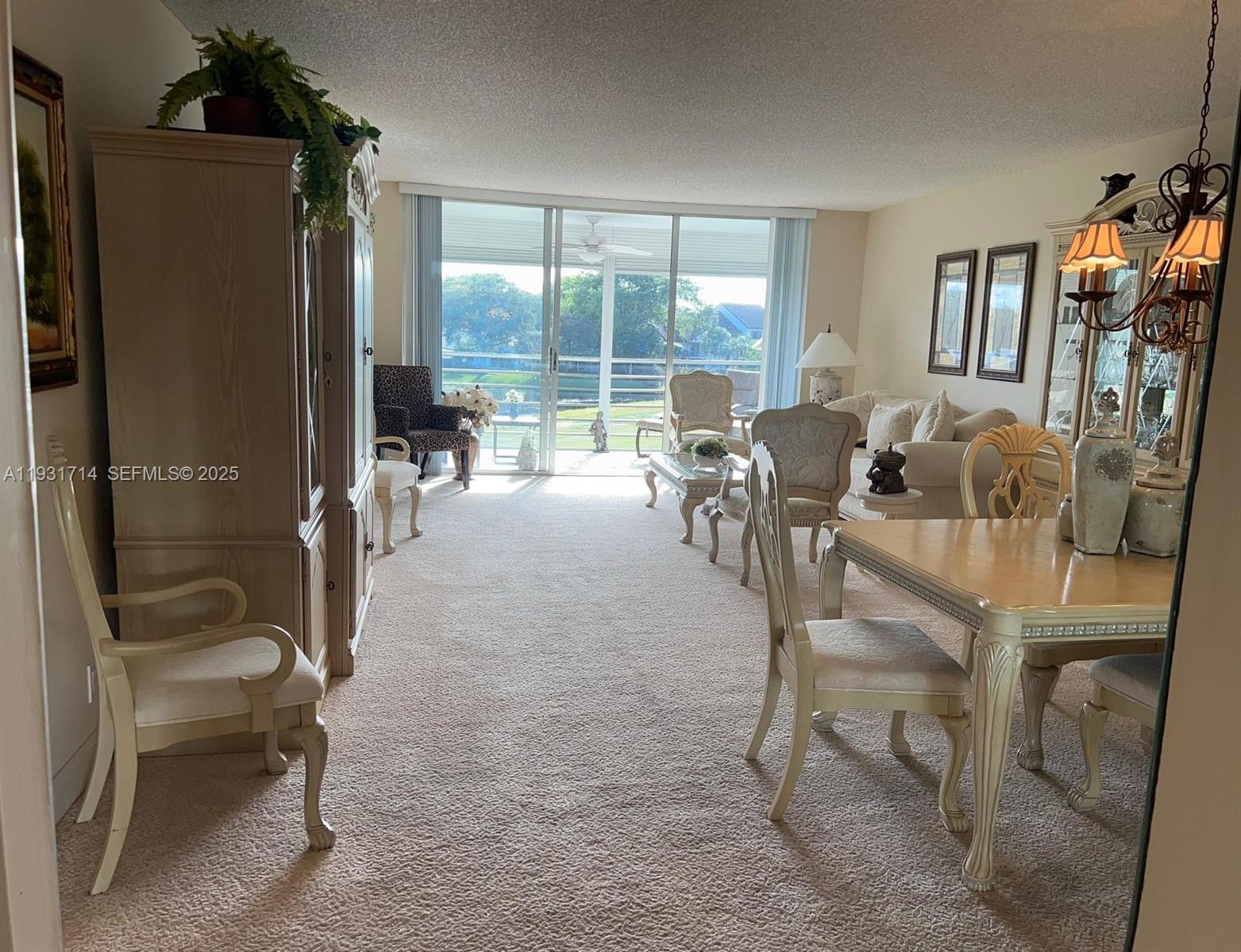 821 Cypress Boulevard, Unit 312 Pompano Beach, FL 33069 - Photo 3 of 52 a dining room with furniture and large windows