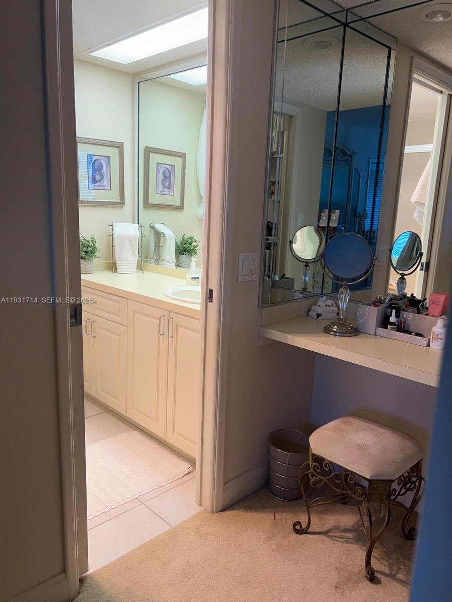 821 Cypress Boulevard, Unit 312 Pompano Beach, FL 33069 - Photo 35 of 52 a bathroom with a toilet a sink and mirror