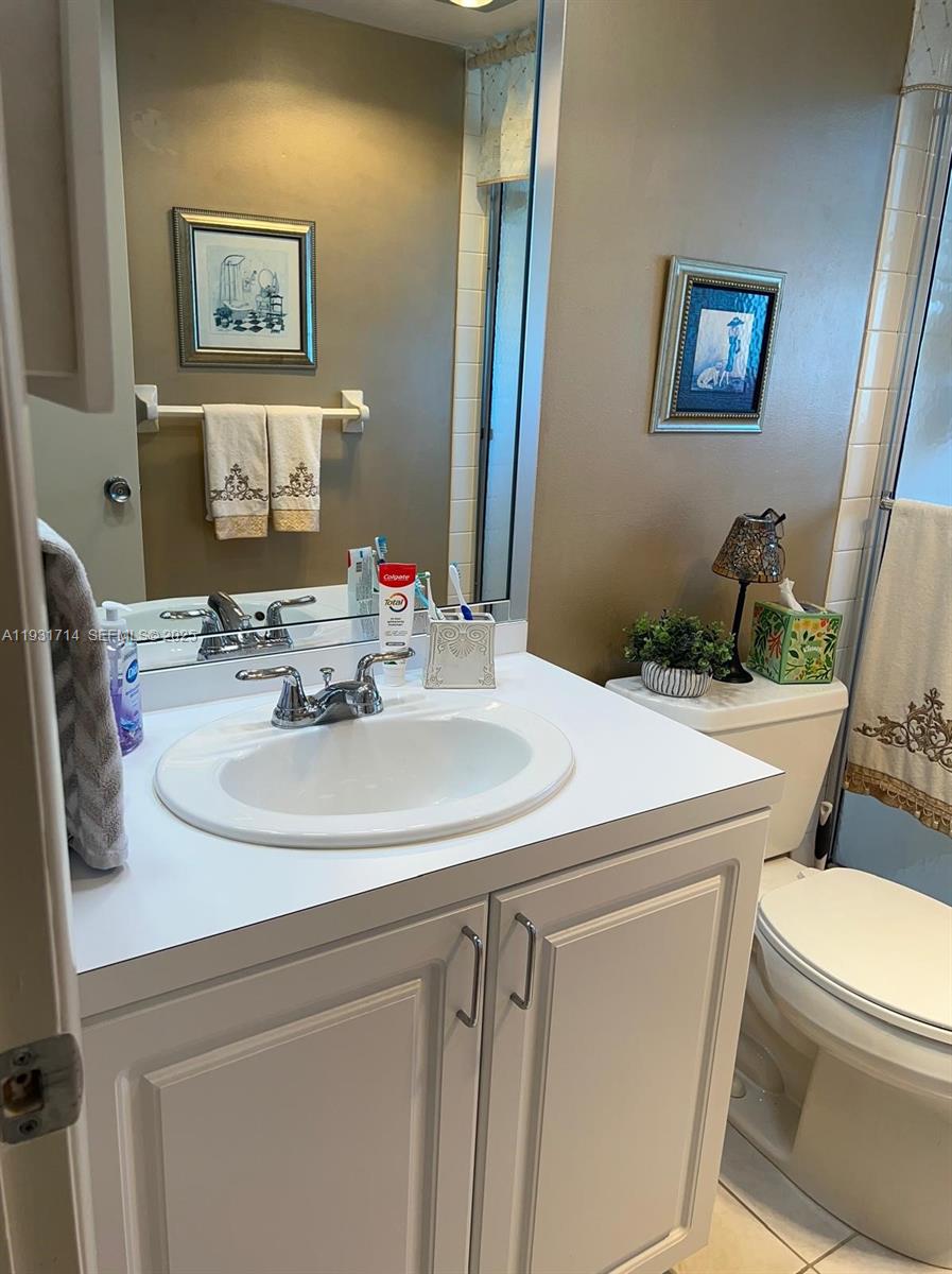 821 Cypress Boulevard, Unit 312 Pompano Beach, FL 33069 - Photo 41 of 52 a bathroom with a sink and a toilet