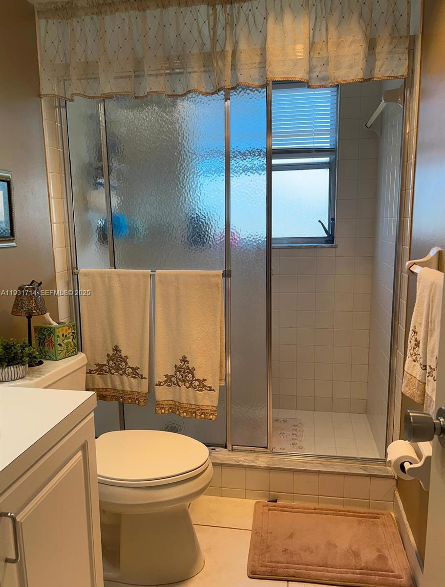 821 Cypress Boulevard, Unit 312 Pompano Beach, FL 33069 - Photo 43 of 52 a bathroom with a toilet and a shower
