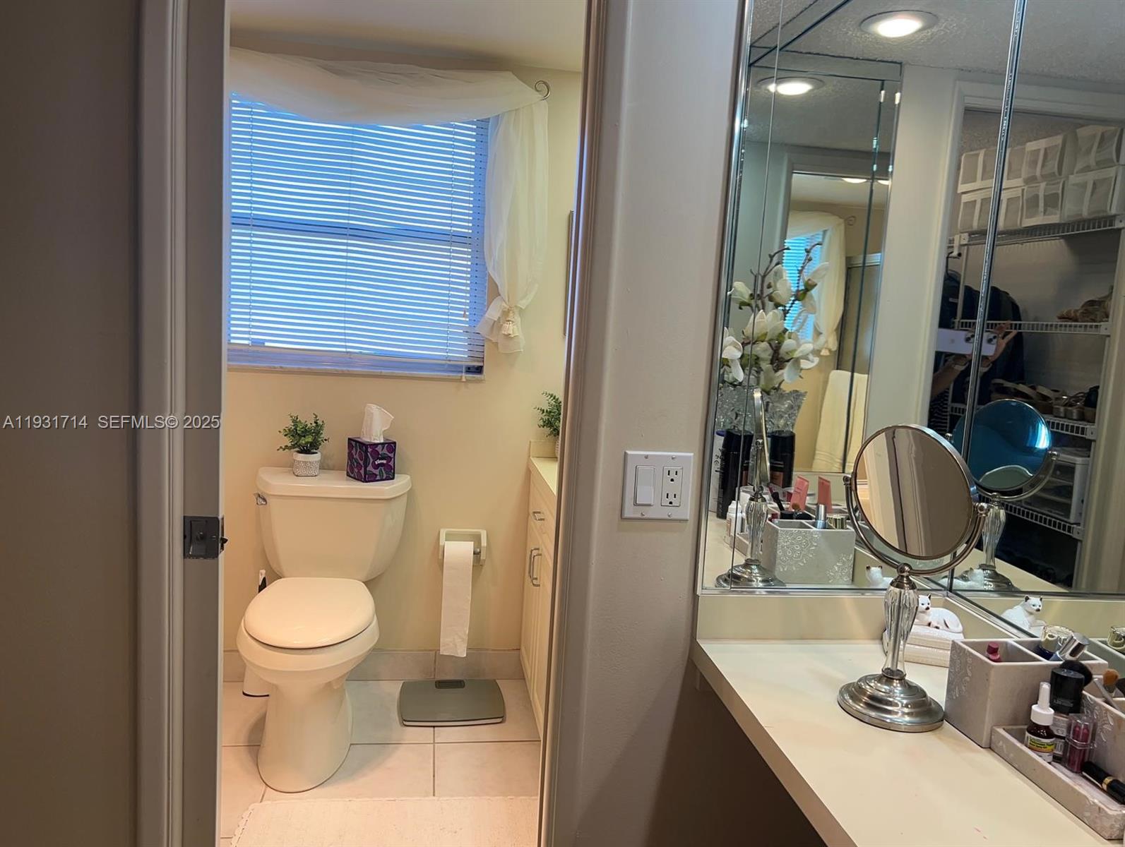 821 Cypress Boulevard, Unit 312 Pompano Beach, FL 33069 - Photo 45 of 52 a bathroom with a sink a toilet and a mirror