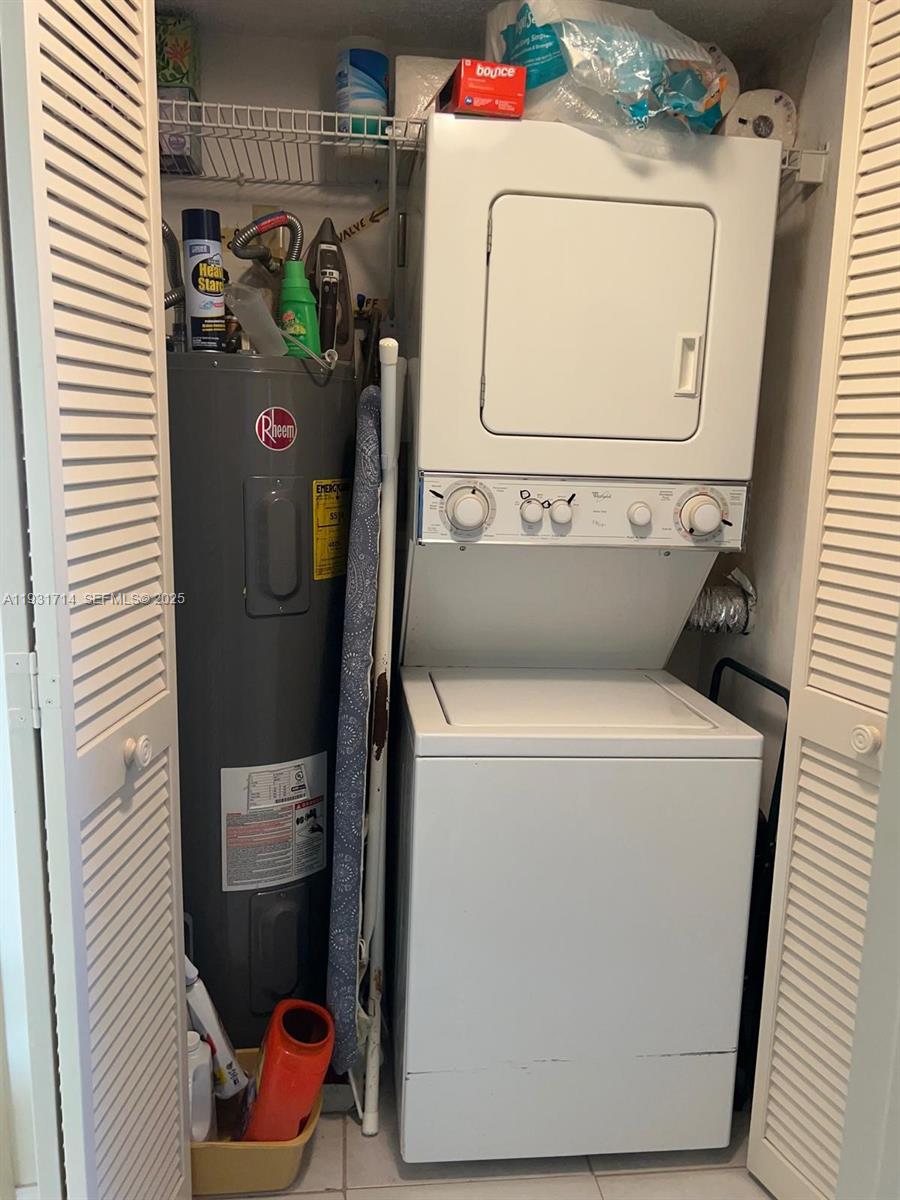 821 Cypress Boulevard, Unit 312 Pompano Beach, FL 33069 - Photo 46 of 52 a utility room with dryer and washer