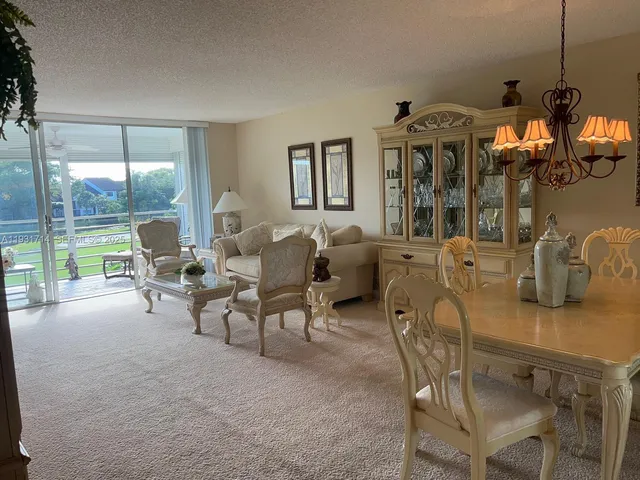 a living room with furniture a flat screen tv and a large window