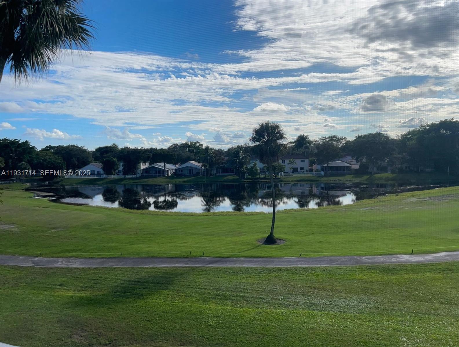821 Cypress Boulevard, Unit 312 Pompano Beach, FL 33069 - Photo 52 of 52 a view of a golf course with a lake