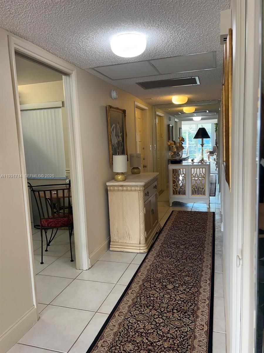 821 Cypress Boulevard, Unit 312 Pompano Beach, FL 33069 - Photo 10 of 52 a kitchen with a sink and a refrigerator