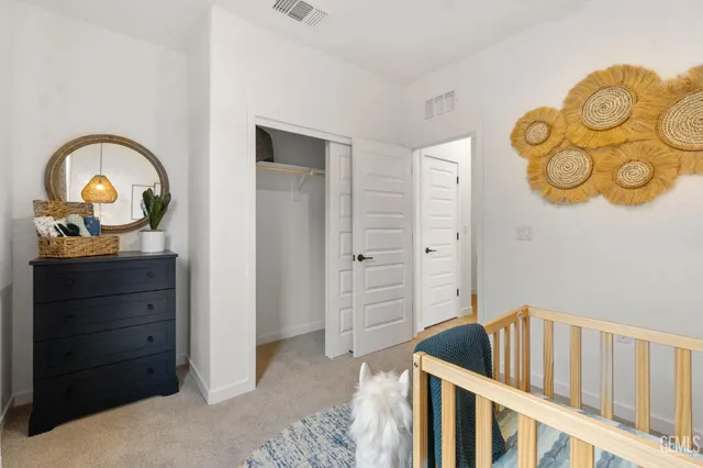 a spacious bedroom with a bed and a chandelier