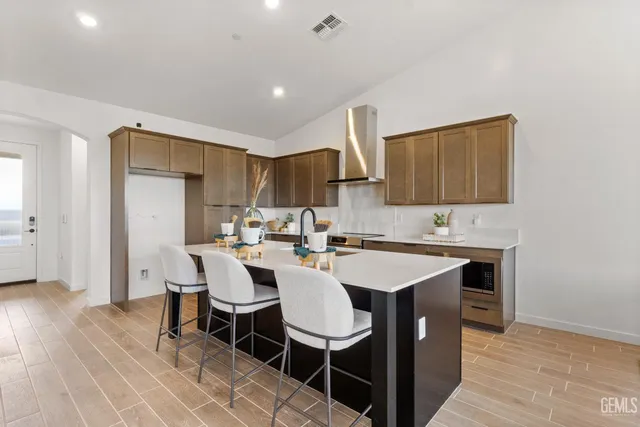 a kitchen with a sink cabinets and wooden floor
