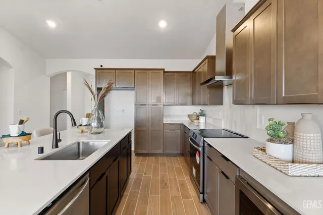 a kitchen with stainless steel appliances a sink stove and cabinets