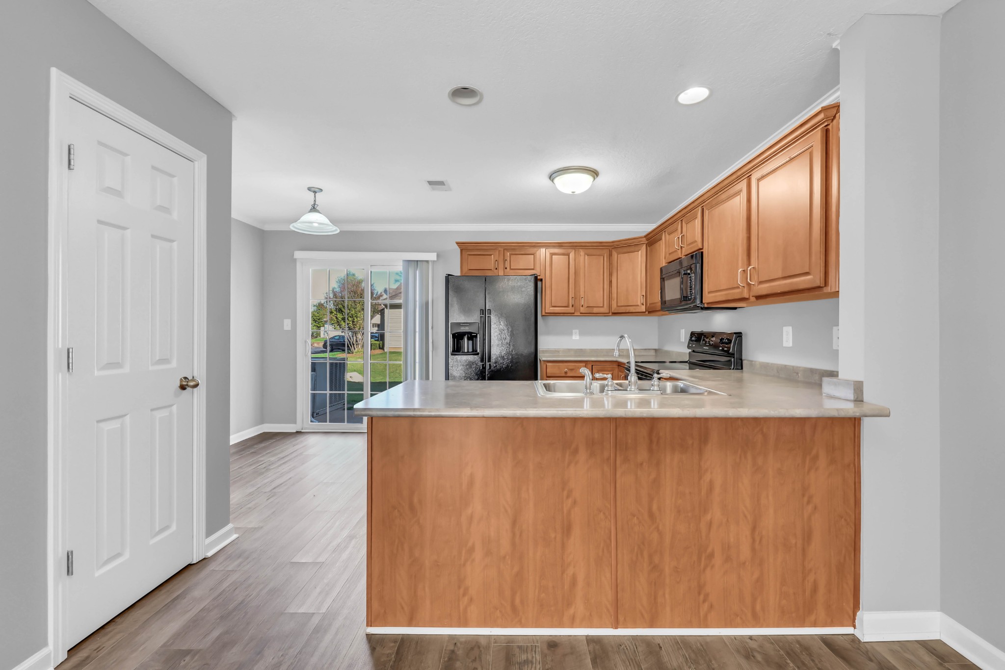 116 Alexander Boulevard Clarksville, TN 37040 - Photo 10 of 33 a kitchen with stainless steel appliances granite countertop a refrigerator a stove and a sink with wooden floor