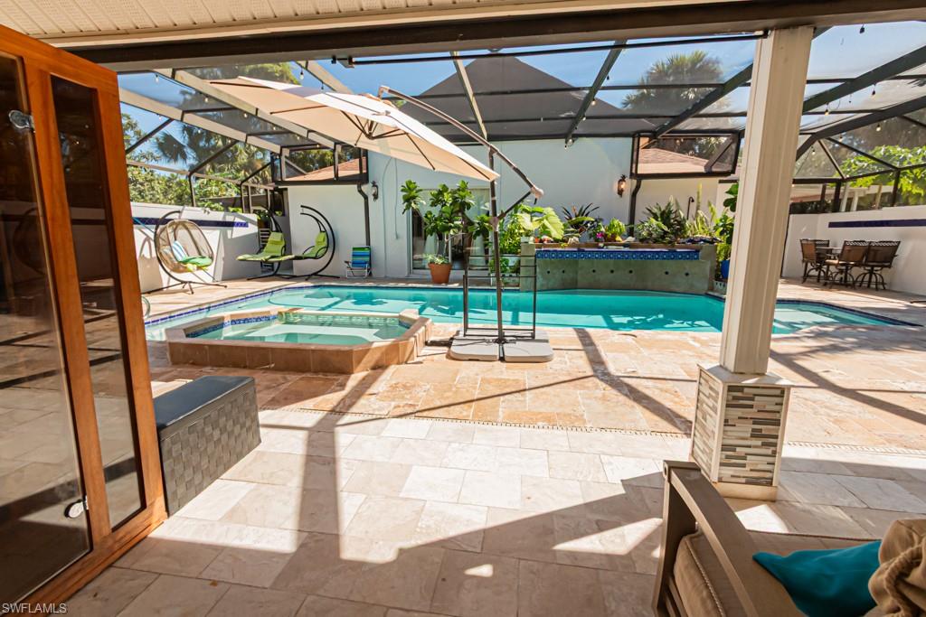 740 31st Street Southwest Naples, FL 34117 - Photo 13 of 50 a view of a patio with a table and chairs