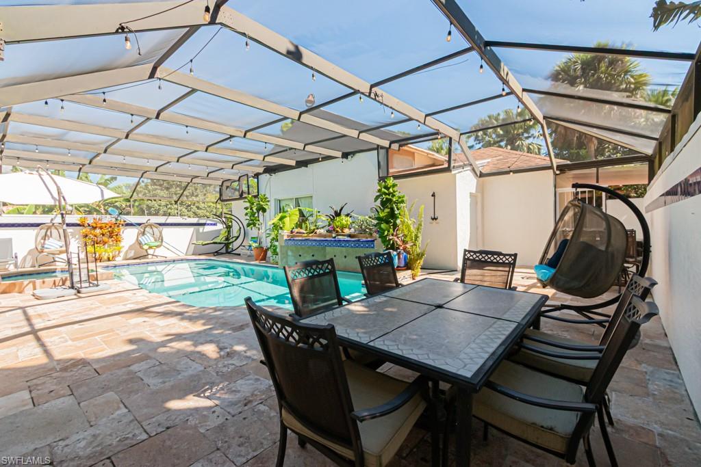 740 31st Street Southwest Naples, FL 34117 - Photo 18 of 50 a view of a patio with table and chairs and potted plants
