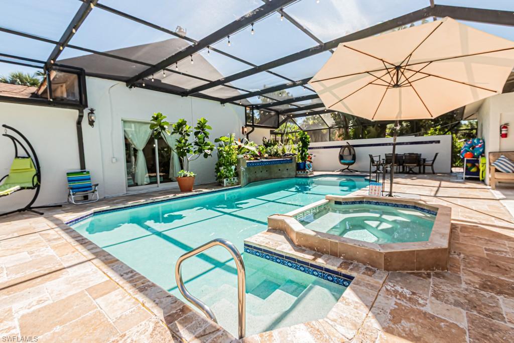 740 31st Street Southwest Naples, FL 34117 - Photo 20 of 50 a view of a swimming pool with a patio