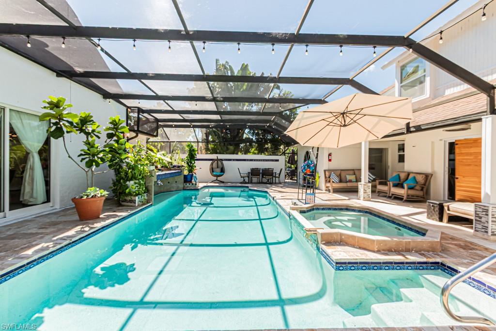 740 31st Street Southwest Naples, FL 34117 - Photo 21 of 50 a view of a swimming pool with a patio