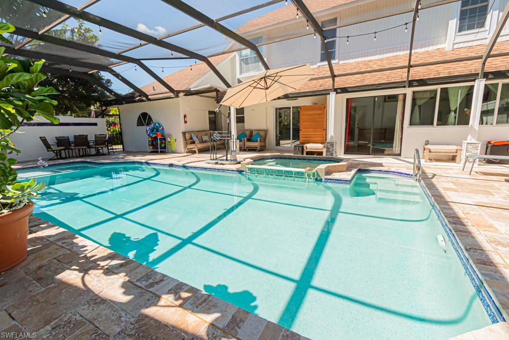 740 31st Street Southwest Naples, FL 34117 - Photo 22 of 50 a view of a patio with table and chairs under an umbrella