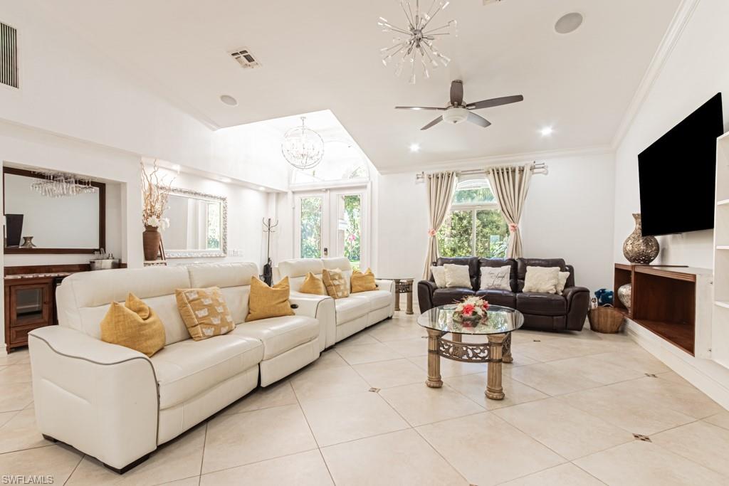 740 31st Street Southwest Naples, FL 34117 - Photo 25 of 50 a living room with furniture and a flat screen tv