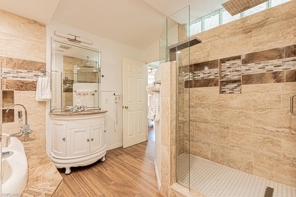 740 31st Street Southwest Naples, FL 34117 - Photo 41 of 50 a bathroom with a mirror and a shower
