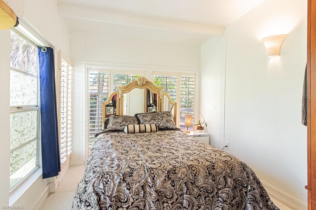 740 31st Street Southwest Naples, FL 34117 - Photo 47 of 50 a bedroom with a bed and a large window