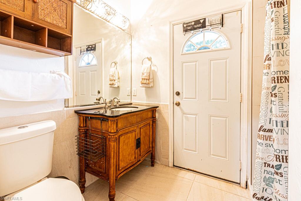 740 31st Street Southwest Naples, FL 34117 - Photo 49 of 50 a bathroom with a granite countertop sink and a mirror