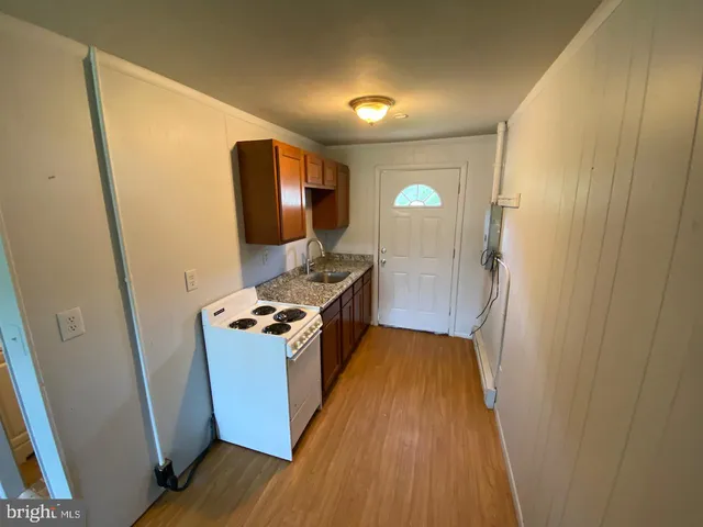 a view of a kitchen from a hallway