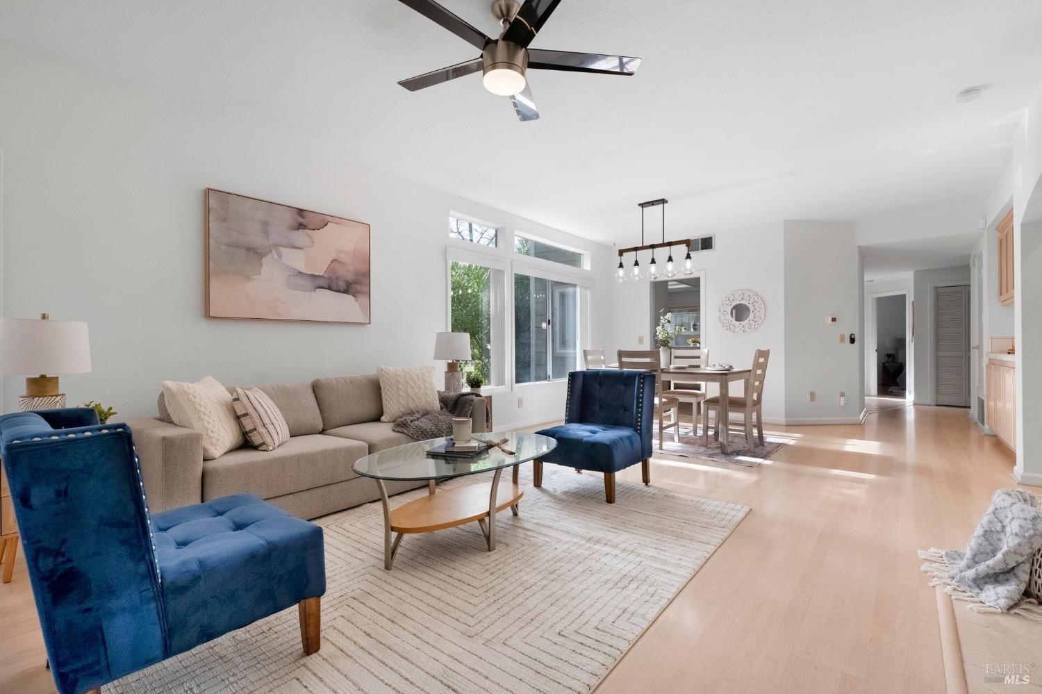Living room with fireplace, private patio, formal dining area, and wet bar