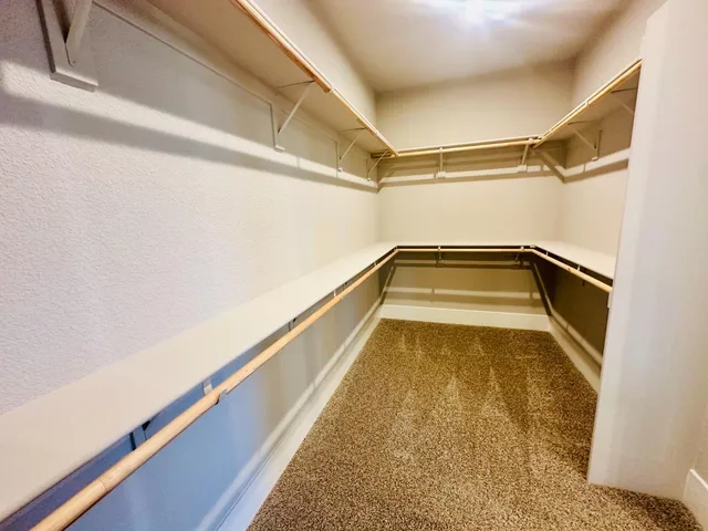 a living room with furniture and stairs