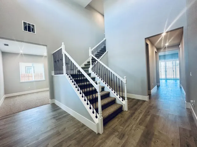 a view of entryway with wooden floor and stairs