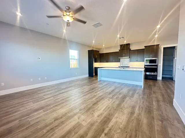 a view of kitchen with cabinets and wooden floor