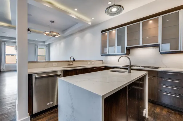 a kitchen with stainless steel appliances a stove a sink and a refrigerator