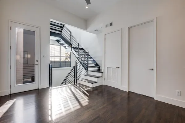 an empty room with windows and a flat screen tv