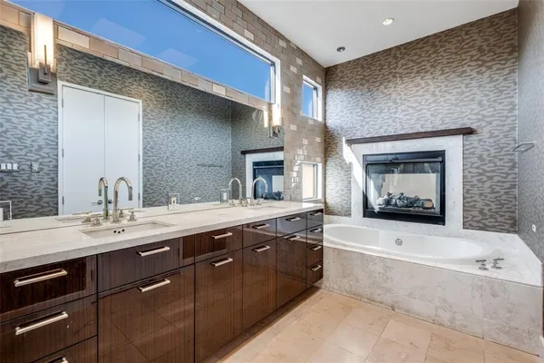 a bathroom with a sink a mirror and a shower
