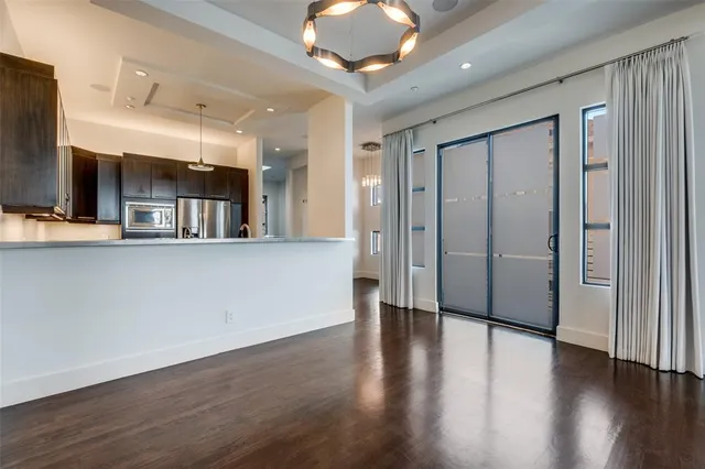 a view of a kitchen with a sink and a large mirror
