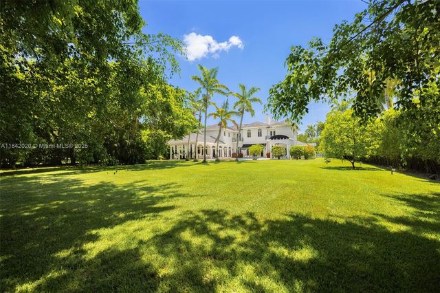 a house view with swimming pool in front of the house