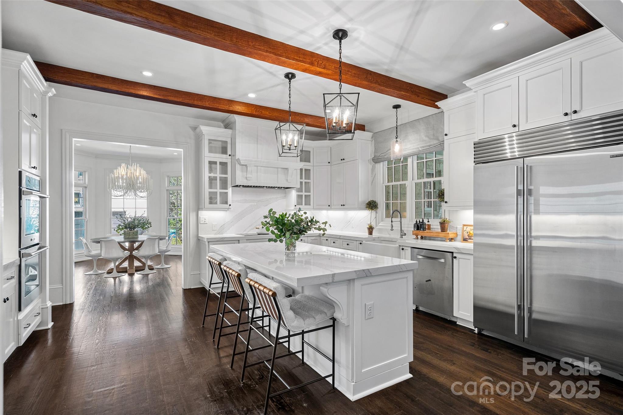 3212 Lazy Branch Road Charlotte, NC 28270 - Photo 16 of 47 a kitchen with stainless steel appliances a dining table chairs stove and refrigerator