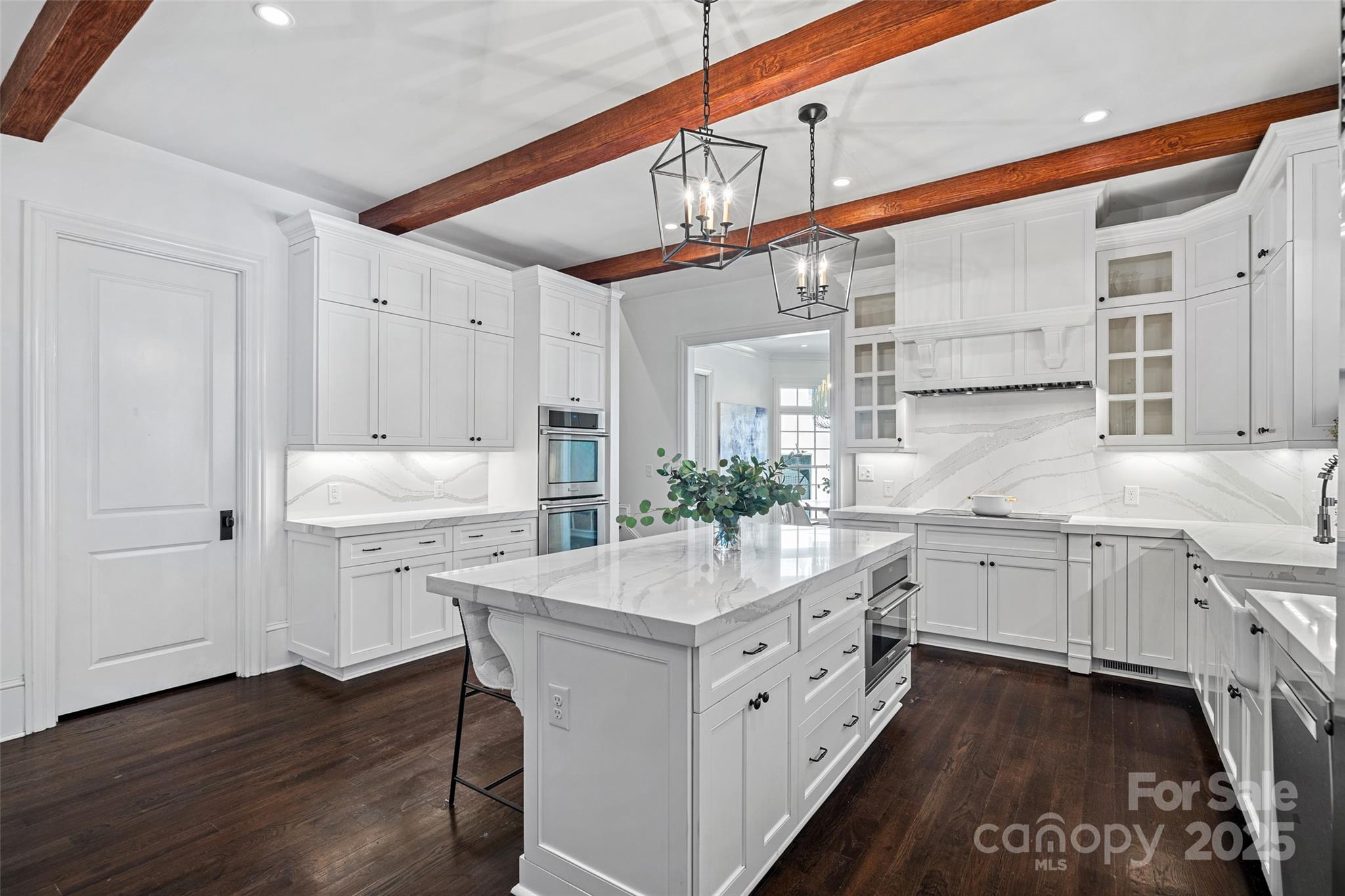 3212 Lazy Branch Road Charlotte, NC 28270 - Photo 17 of 47 a kitchen with white cabinets and wooden floor