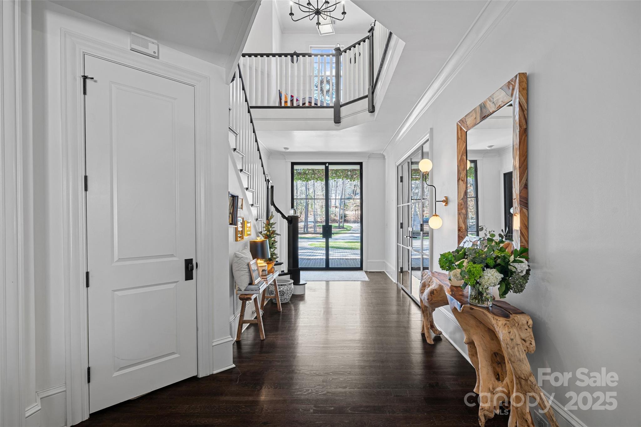 3212 Lazy Branch Road Charlotte, NC 28270 - Photo 6 of 47 a view of an entryway with wooden floor and a chandelier